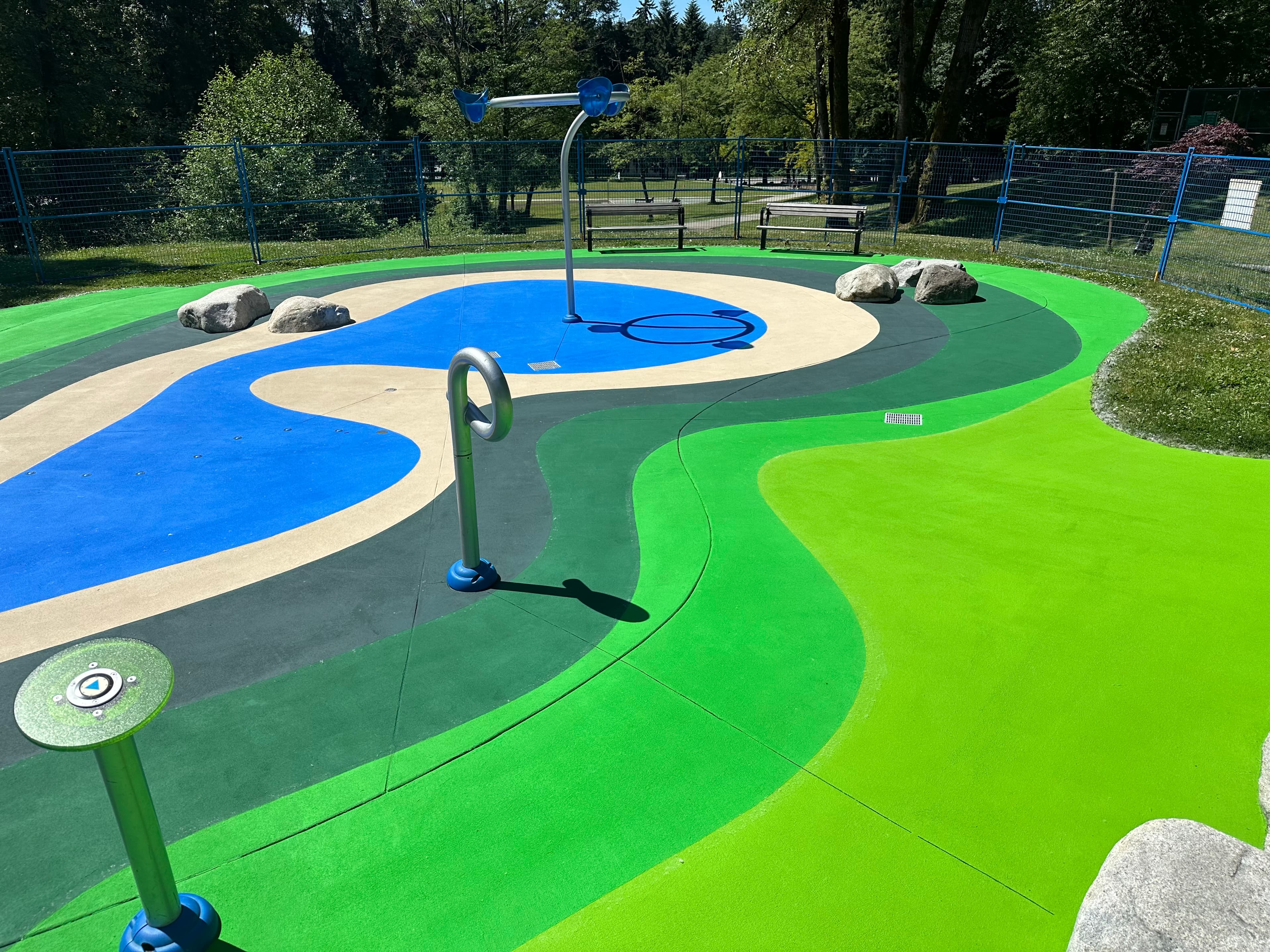 Splash pad surfacing in slip-resistant coloured surface coating — a park spray pad, Canada