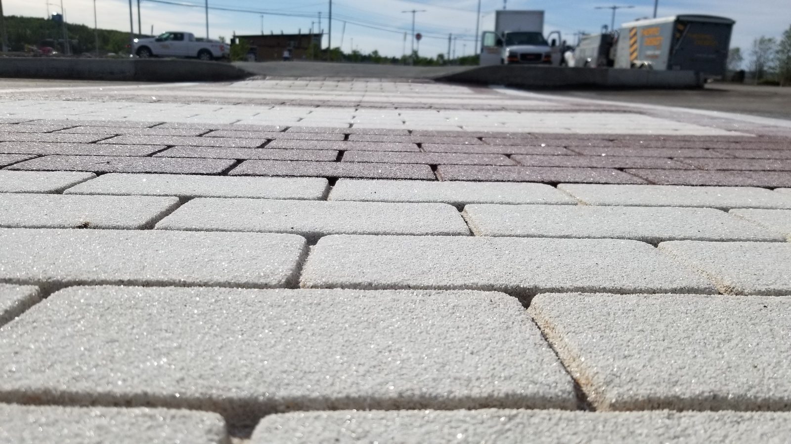 Thermoplastic aggregate-reinforced crosswalk providing tactile feedback and visual contrast in a wet-weather condition
