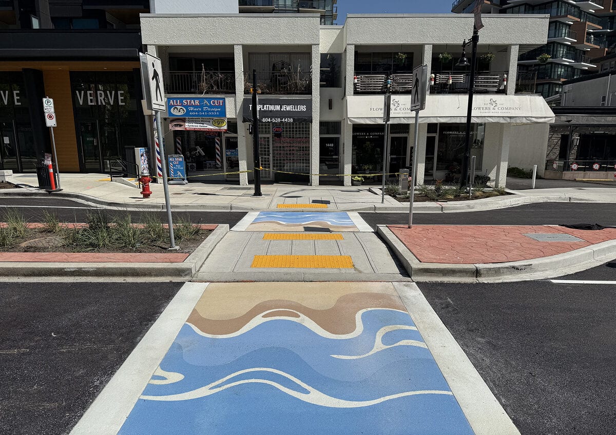 White Rock's Seaside Stroll decorative crosswalk on Johnston Road featuring flowing wave-inspired artwork by artist Amy Bao